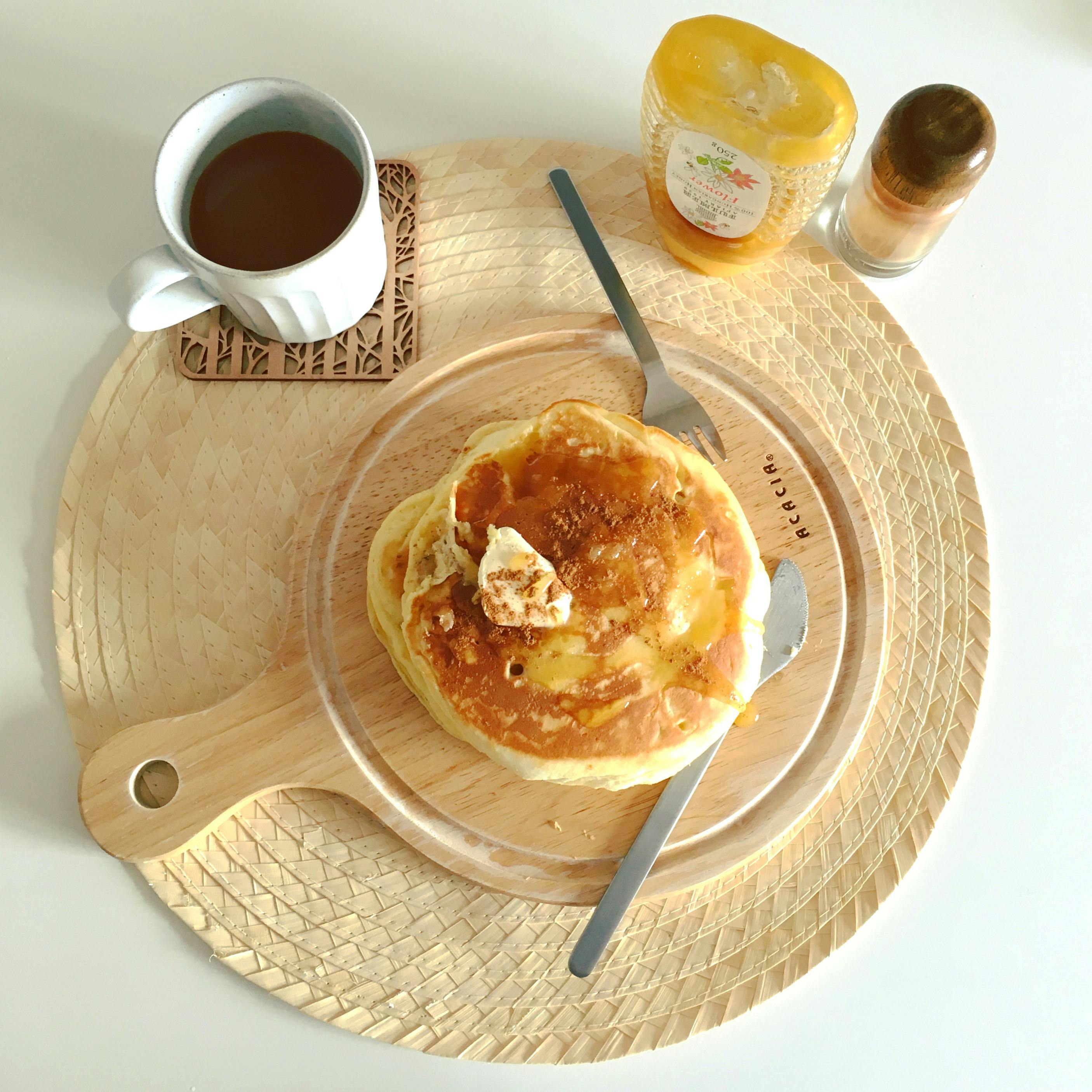 Stack of golden pancakes with butter melting on top